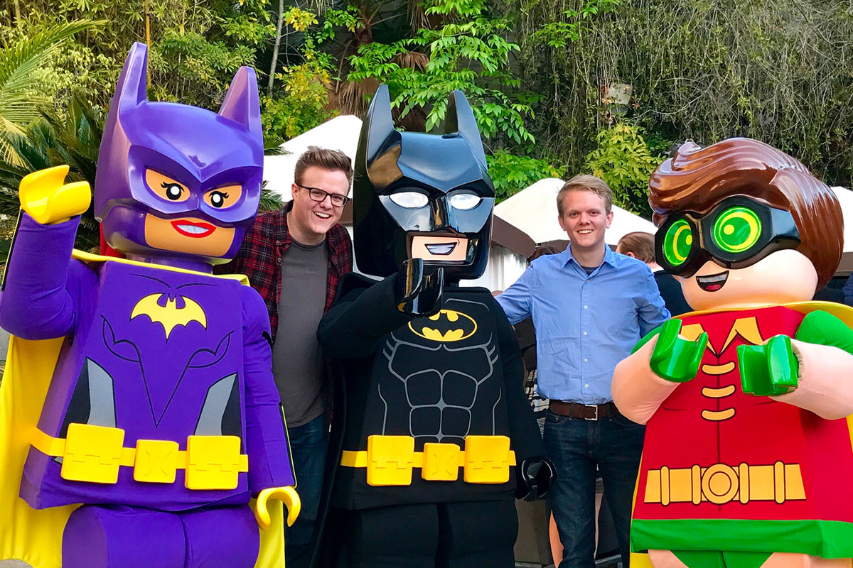 Ben Murphy poses with life-sized Lego figures of Batman and Robin