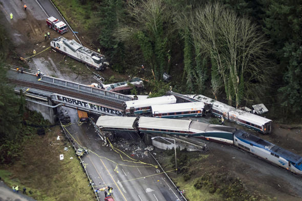 Cars from an Amtrak train that derailed lie spilled onto Interstate 5 on December 18, 2017, in DuPont, Washington. (Bettina Hansen/The Seattle Times)